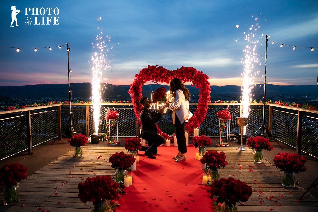 Dream of Roses proposal – rose heart with fireworks, man kneeling, panoramic city view