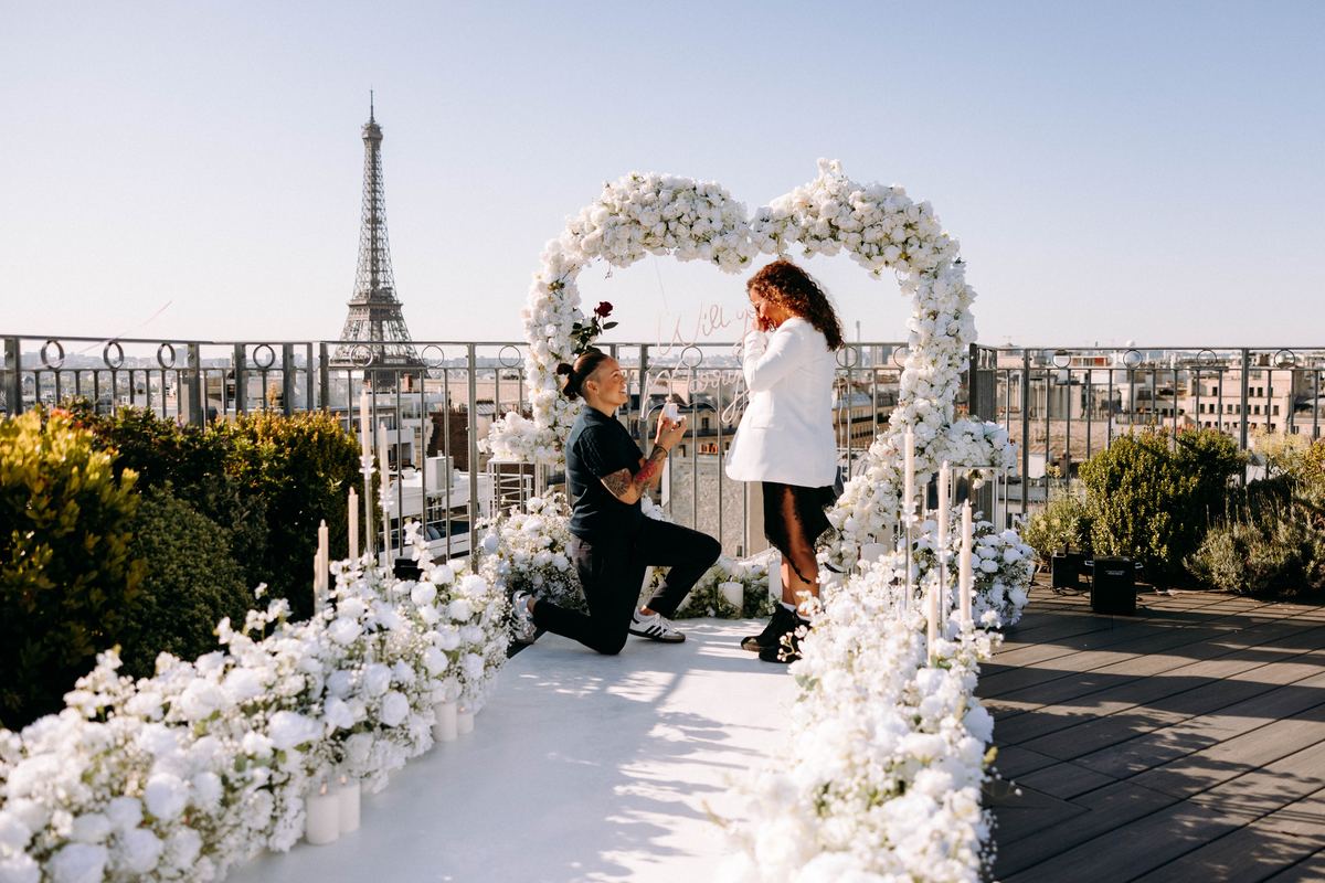 Marriage proposal in Paris – rooftop with white flower heart and Eiffel Tower view