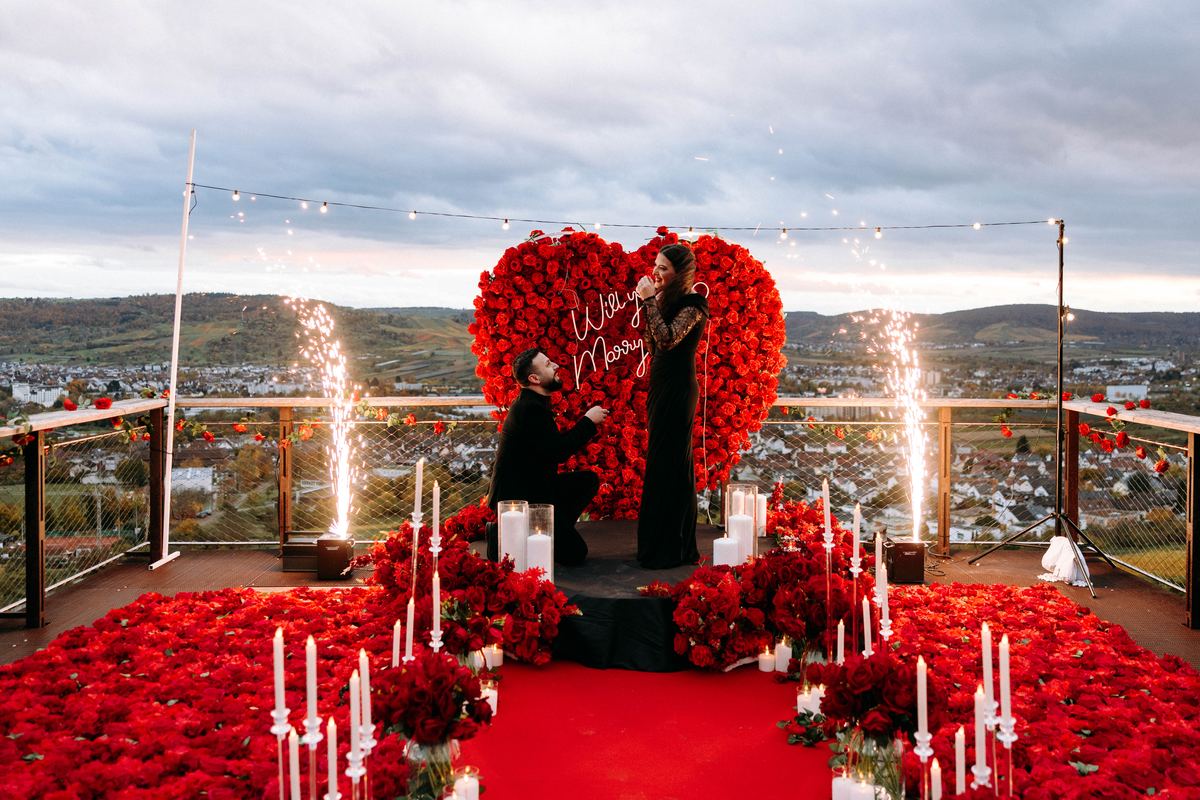 Marriage proposal in vineyard – red heart decoration with fireworks and panoramic view