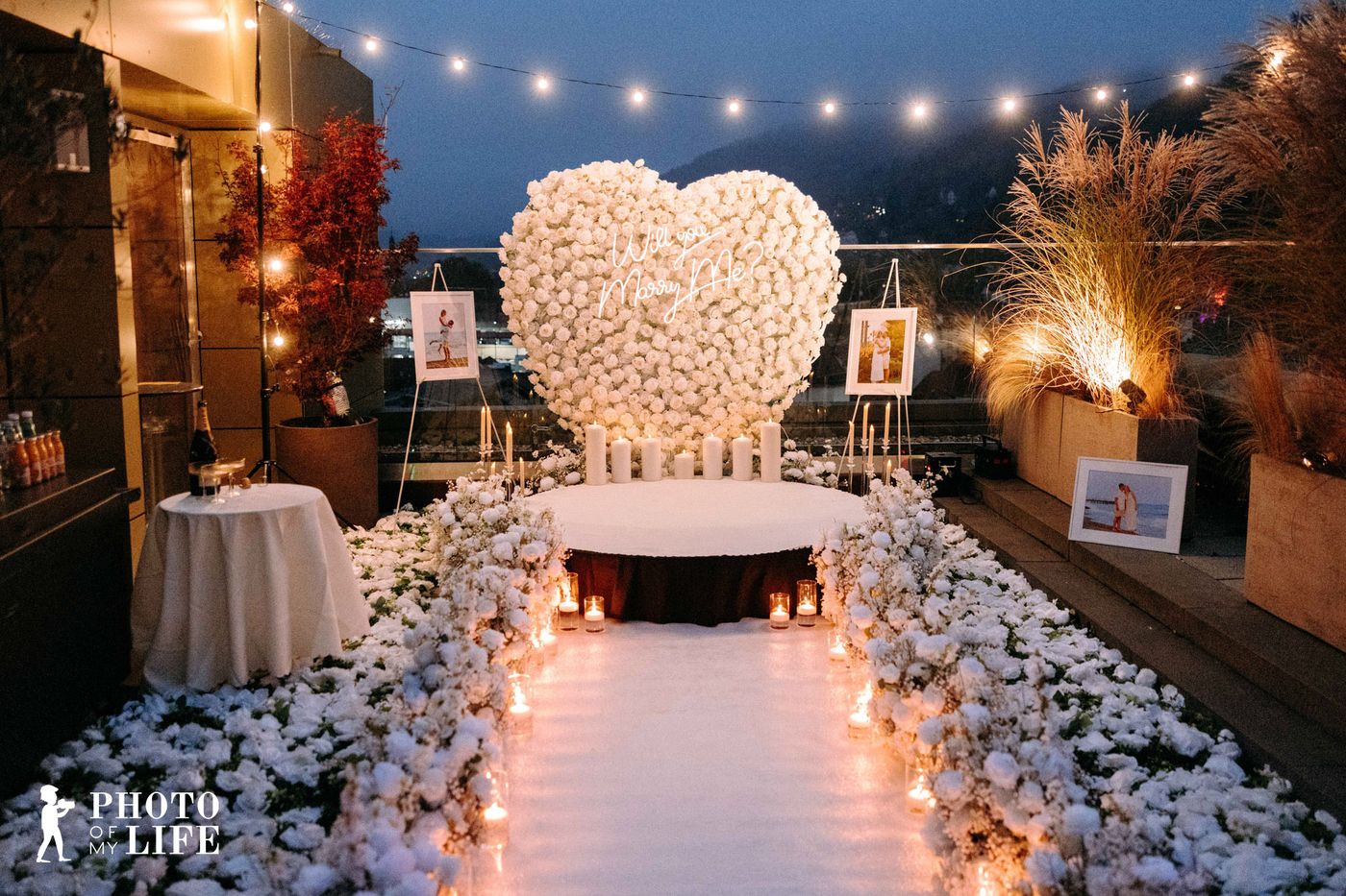 Power of Love proposal – white heart decoration with candles and romantic lake view