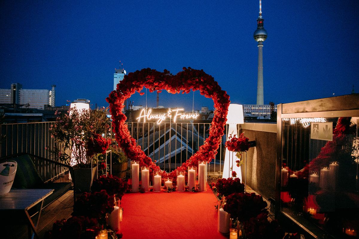 Marriage proposal in Berlin – TV Tower rooftop with red heart and neon sign at night