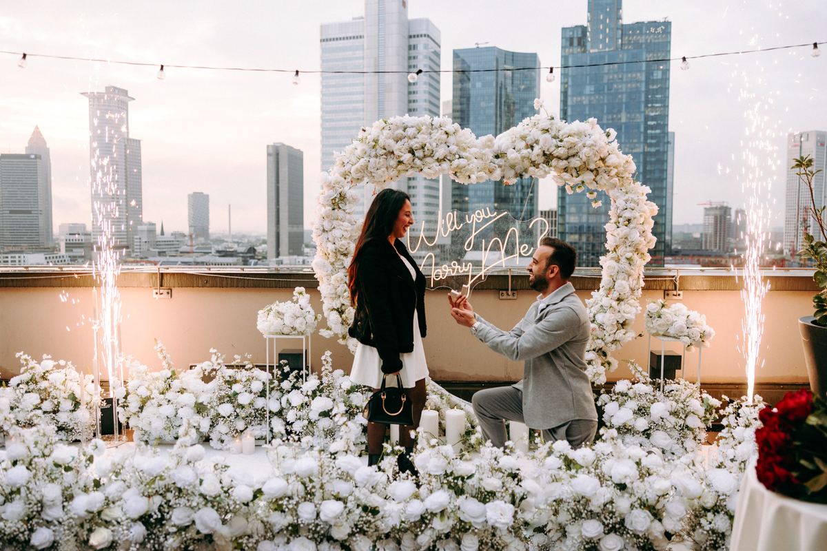 Marriage proposal in Frankfurt – skyline with white heart, fireworks, man kneeling